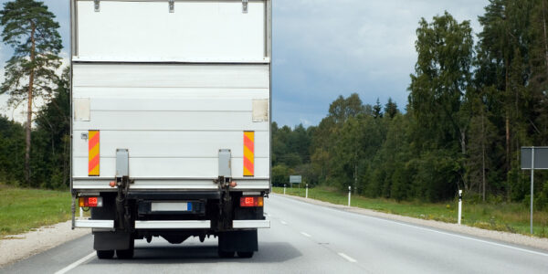 On The Road - White Cargo Van Transporting Goods