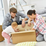 Baby-playing-with-box-bassys-removals